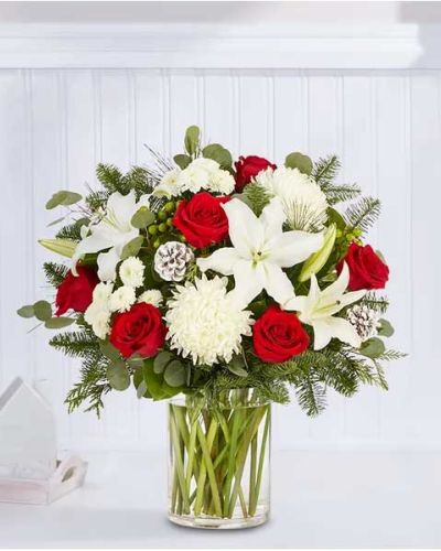 <p>We’ve taken one of our best-selling bouquet designs and filled it with all the joyful colors and textures of the holiday season. An abundant, garden-inspired mix of blooms is gathered with glittery natural accents inside a clear glass vase. It’s a gift guaranteed to make a grand impression at every gathering.</p>
<ul>
<li>All-around arrangement with red roses, white Oriental lilies, football mums and button poms, green hypericum; accented with silver dollar eucalyptus, assorted Christmas greens and glittered pinecones</li>
<li>Artistically designed in a clear glass vase</li>
<li>Extra large arrangement measures approximately 33"H x 20"W</li>
<li>Large arrangement measures approximately 31"H x 19"W</li>
<li>Medium arrangement measures approximately 28"H x 19"W</li>
<li>Small arrangement measures approximately 27H x 18"W</li>
<li>Our florists hand-design each arrangement, so colors, varieties and container may vary due to local availability</li>
<li>To ensure lasting beauty, Oriental lilies may arrive in bud form and will fully bloom over the next few days</li>
</ul>